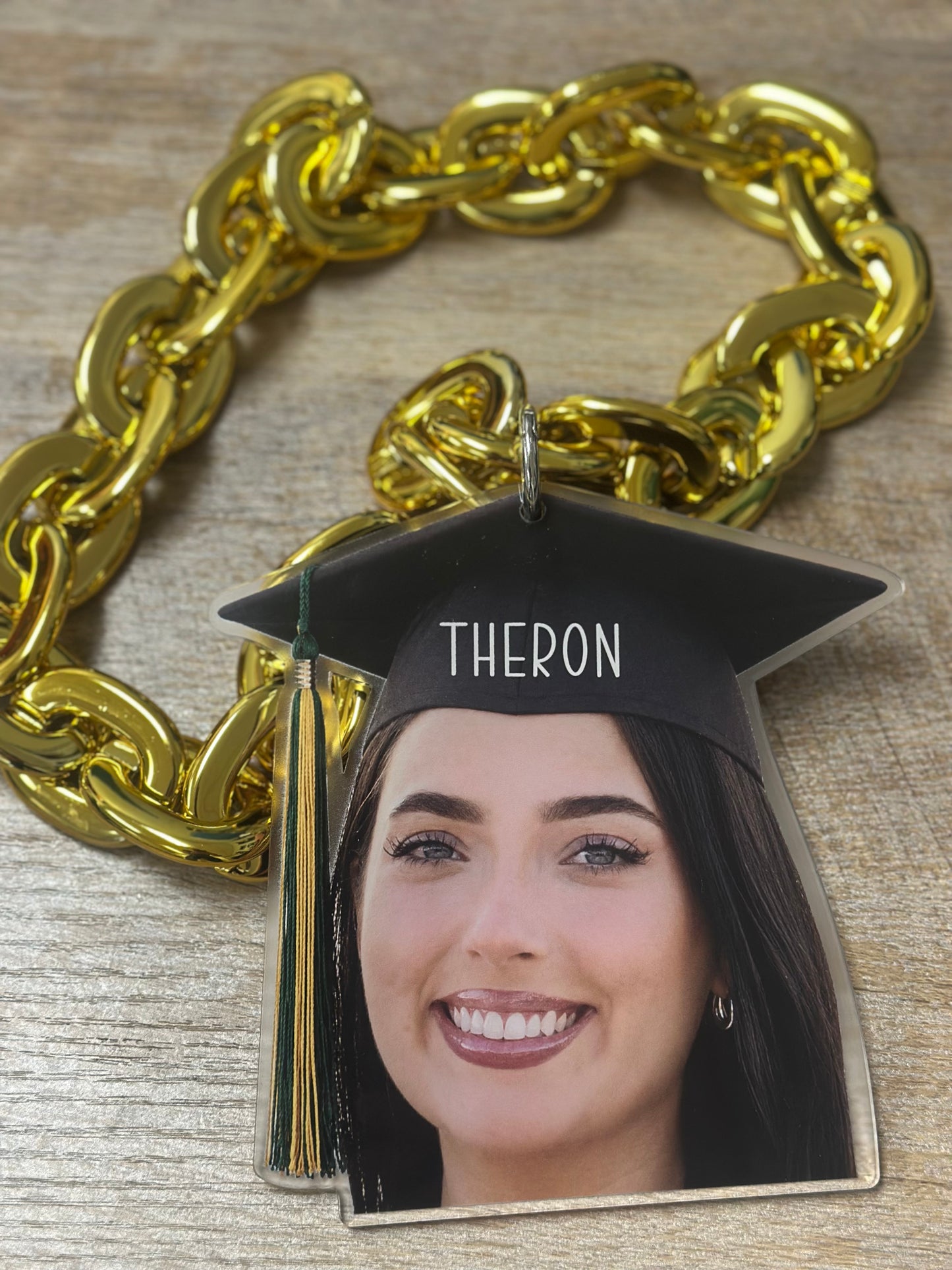 Custom acrylic face cutout attached to a hype chain worn at a graduation party