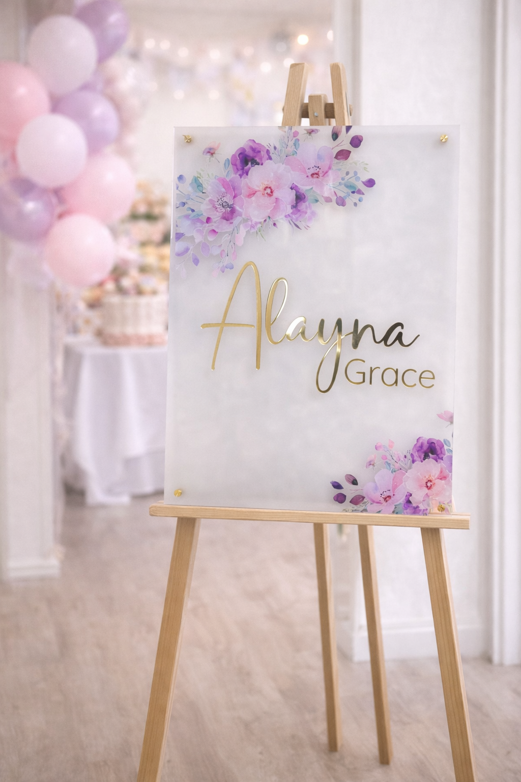 Personalized baby shower welcome sign on frosted acrylic with gold name lettering and pink purple floral design, 20x28 nursery decor sign on easel